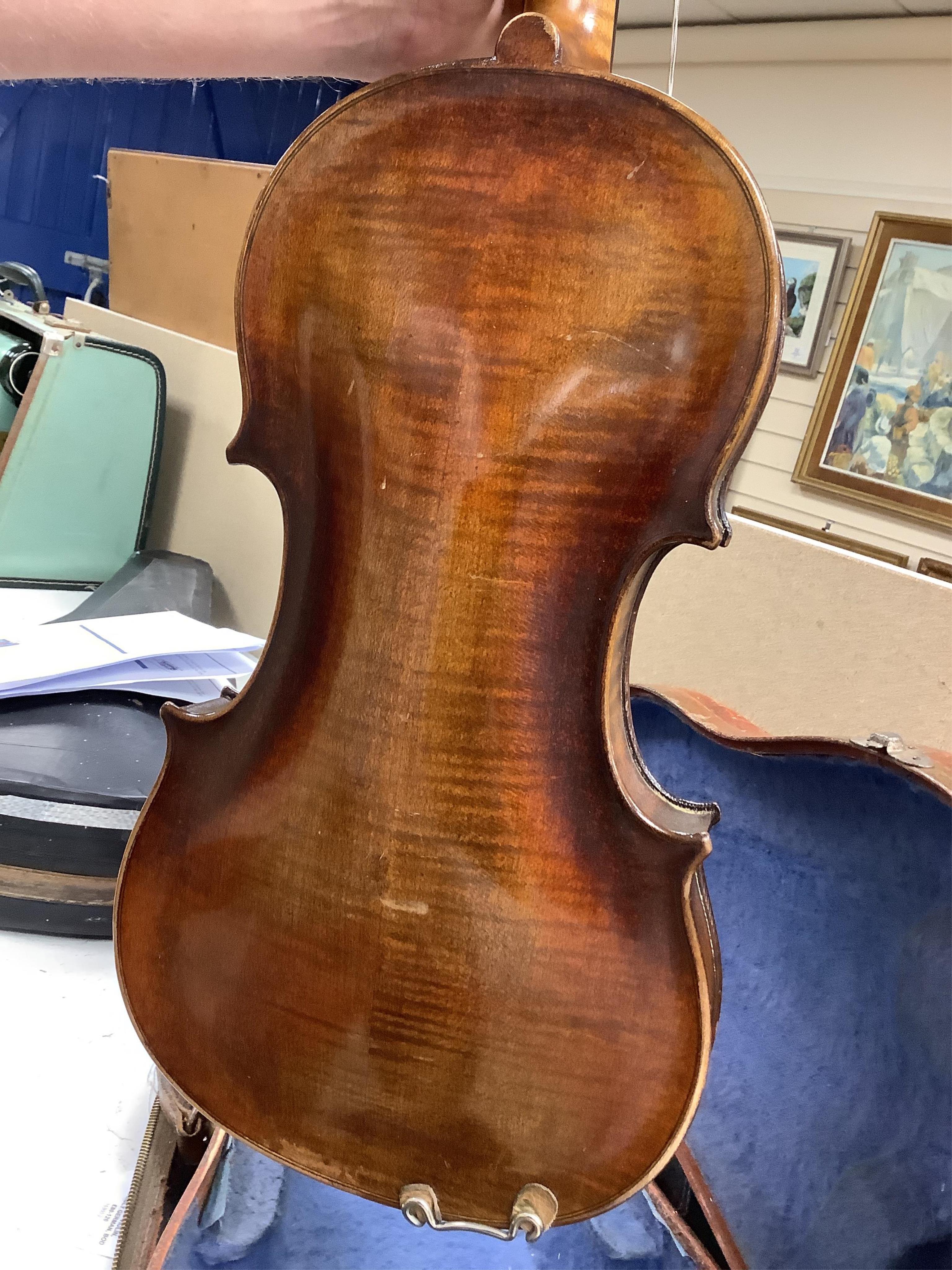 A cased violin, possibly German, body 35.5cm, in a good wooden case with canvas outer cover. Condition - fair